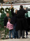 Barack Obama and his two daughters shop for a Christmas tree in Chicago under heavy Secret Service protection on December 14, 2008.