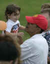 Barack Obama lifts a child from the crowd after playing a round of golf with Obama's friends at the Mid Pacific Country Club in Kailua, Hawaii on December 29, 2008.