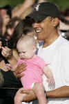 Barack Obama lifts child from crowd after workout at the Semper Fit gym on the Kaneohe Bay Marine Corps Base in Kailua, Hawaii on December 31, 2008.