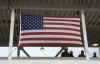 Workers look out from a review stand built for President Barack Obama's January 20th inauguration.