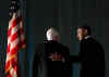 Barack Obama leaves the stage with John McCain at the bipartisan dinner in honor of Senator John McCain. Barack and Michelle Obama do their pre-inauguration duties the day before Obama's inauguration.