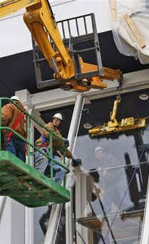 Bullet proof glass gets installed on the Presidential review stand.