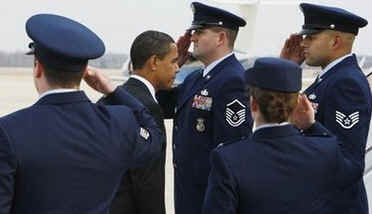 President Barack Obama is saluted by officers at Andrews Air Force Base in Maryland before boarding a flight on Air Force One to Fort Meyers, Florida for a town hall style meeting to discuss Obama's economic stimulus plan.