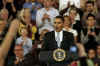 President Barack Obama is welcomed to the stage of the Harborside Event Center in Fort Meyers, Florida by Florida Governor Charlie Crist on February 10, 2009. President Obama spoke to the crowd then answered questions.