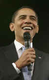 President Barack Obama is welcomed to the stage of the Harborside Event Center in Fort Meyers, Florida by Florida Governor Charlie Crist on February 10, 2009. President Obama spoke to the crowd then answered questions.