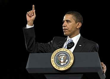 President Barack Obama is welcomed to the stage of the Harborside Event Center in Fort Meyers, Florida by Florida Governor Charlie Crist on February 10, 2009. President Obama spoke to the crowd then answered questions.