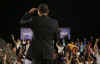 President Barack Obama is welcomed to the stage of the Harborside Event Center in Fort Meyers, Florida by Florida Governor Charlie Crist on February 10, 2009. President Obama spoke to the crowd then answered questions.