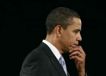 President Barack Obama is welcomed to the stage of the Harborside Event Center in Fort Meyers, Florida by Florida Governor Charlie Crist on February 10, 2009. President Obama spoke to the crowd then answered questions.