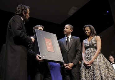 President Barack Obama and First Lady Michelle Obama attend the Grand Re-Opening of Ford's Theatre in Washington on February 11, 2009. President Obama meets a Lincoln actor, receives a copy of the Gettysburg Address (photo), and speaks just below the box where President Abraham Lincoln was shot.