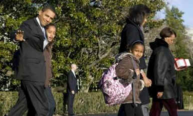 President Barack Obama and his family walk across the South Lawn of the White House to Marine One.