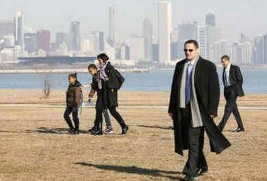 President Barack Obama and family walk to depart on Marine One and then on to Air Force One at Chicago's O'Hare Airport for a return to the White House after a President's Day weekend at Obama's Chicago home.