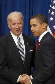 President Barack Obama shakes hands with Joe Biden after signing the $787 billion American Recovery and Investment Plan at the Denver Museum of Nature and Science.