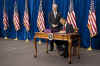 President Barack Obama signs the $787 billion American Recovery and Investment Plan into law at the Denver Museum of Nature and Science.