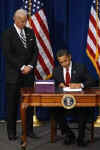 President Barack Obama signs the $787 billion American Recovery and Investment Plan into law at the Denver Museum of Nature and Science.