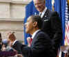 Obama jokes with Biden and the crowd about the ten pens used to sign the stimulus package document.