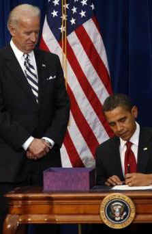 President Barack Obama signs the $787 billion American Recovery and Investment Plan into law at the Denver Museum of Nature and Science.