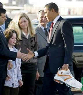 President Obama receives an autographed shoe from airport greeters in Phoenix. The shoe belonged to Phoenix Suns basketball star Shaquille O'Neil.