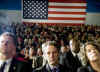 Timothy Geithner watches President Barack Obama speak on his plans to assist struggling homeowners who are facing foreclosure. President Obama spoke at the Dobson High school in Mesa, Arizona on February 18, 2009. Photo of front page of speech (center left photo).