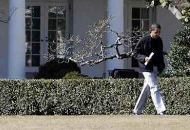 A casually dressed President Obama leaves the Oval Office of the White House to attend a Sunday family event in Washington.