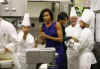 First Lady Michelle Obama meets with White House Executive Chef Cristeta Comerford and the White House kitchen staff to preview the meals for the Governors Dinner in the State Dining Room later that evening. 