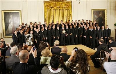 President Barack Obama presents the Commander In Chief Trophy to the Naval Academy Football Team in the East Room of the White House.