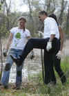 President Barack Obama gets muddy shoes planting trees with volunteers at the Kenilworth Aquatic Gardens.