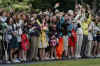 Children touring the White House wave and cheer President Obama.