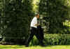 After greeting guests at the ceremony President Obama,  followed by White House aides, walked across the South Lawn to the Oval Office.