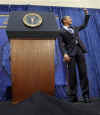 President Obama is introduced by FBI Director Robert Mueller who gives Obama an FBI cap and two teddy bears for daughters Sasha and Malia.