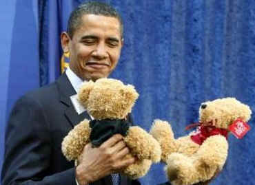 President Obama is introduced by FBI Director Robert Mueller who gives Obama two teddy bears for daughters Sasha and Malia.