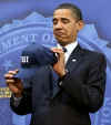 President Obama is introduced by FBI Director Robert Mueller who gives Obama an FBI cap.