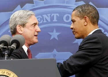 President Obama is introduced by FBI Director Robert Mueller who gives Obama an FBI cap and two teddy bears for daughters Sasha and Malia.