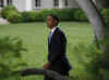 President Barack Obama walks across the South Lawn of the White House to board Marine One.