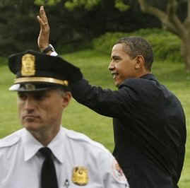 President Barack Obama walks across the South Lawn of the White House to board Marine One.