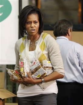 First Lady Michelle Obama and Second Lady Jill Biden join spouses of Members of Congress and other volunteers at a Capital Area Food Bank.