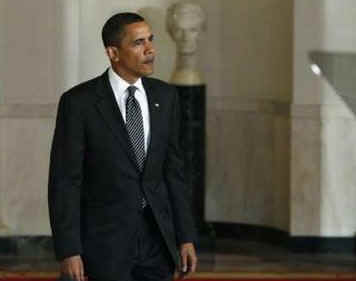 President Barack Obama arrives to speak on the auto industry in the Grand Foyer of the White House on April 30, 2009.