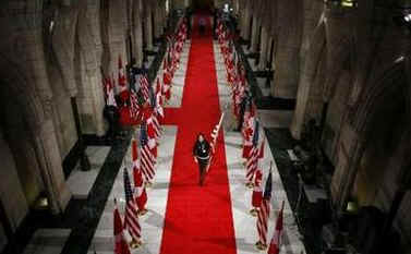 Canadian and American flags are alternately placed down the Hall of Honour in Parliament Hill on February 18, 2009.