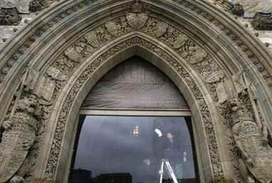 Cleaners wash the bullet proof glass installed in select Parliament Hill windows for Obama's Canadian visit.